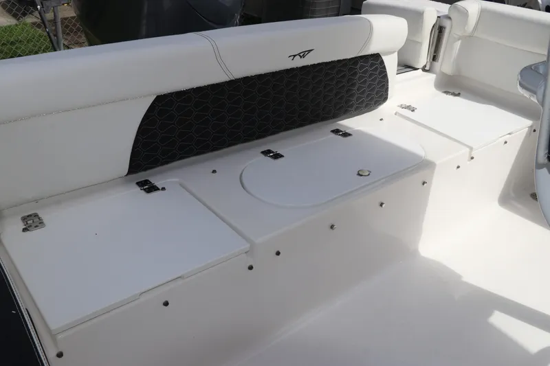 Slide: The Image of 2024 Tidewater 220 LXF boat interior with white seating and storage compartments. - 6