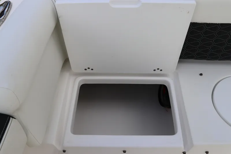 Slide: The Image of 2024 Tidewater 220 LXF boat storage compartment with open lid, showcasing interior space. - 8