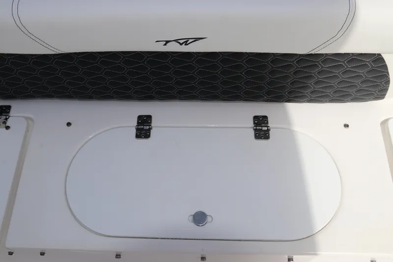 Slide: The Image of 2024 Tidewater 220 LXF boat interior with cushioned seating and storage compartment. - 9