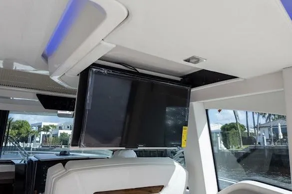 Slide: The Image of 2022 Tiara Sport 43 LE interior with mounted TV and modern seating. - 12