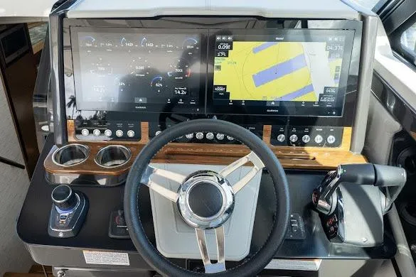 Slide: The Image of 2022 Tiara Sport 43 LE dashboard with dual screens and modern controls. - 17