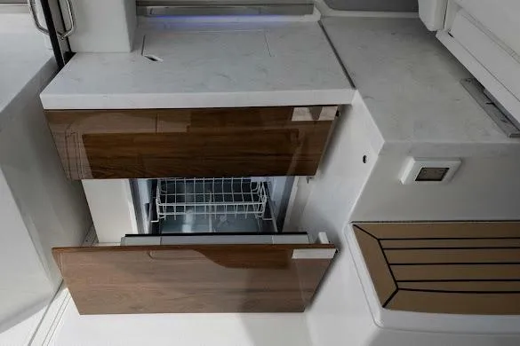 Slide: The Image of 2022 Tiara Sport 43 LE yacht interior with modern cabinetry and built-in dishwasher. - 20