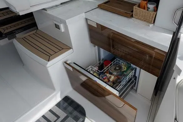 Slide: The Image of 2022 Tiara Sport 43 LE yacht interior with open drawer, showcasing modern kitchen amenities. - 22