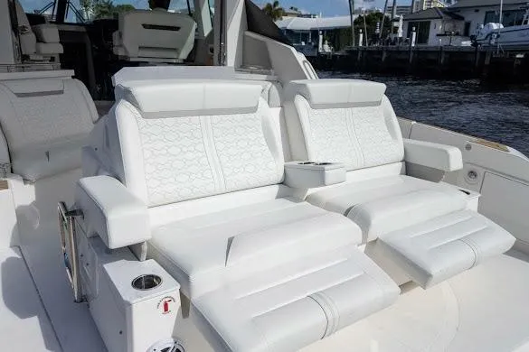 Slide: The Image of 2022 Tiara Sport 43 LE luxury boat seating with white upholstery and armrests. - 23