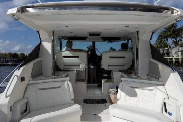 Slide: The Image of 2022 Tiara Sport 43 LE luxury boat interior with white seating and modern design. - 24