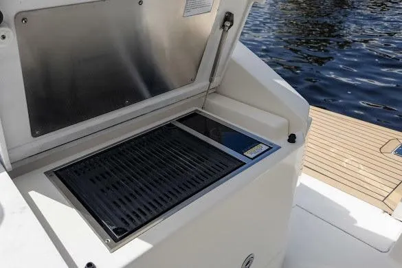 Slide: The Image of Outdoor grill on 2022 Tiara Sport 43 LE boat, near water. - 25