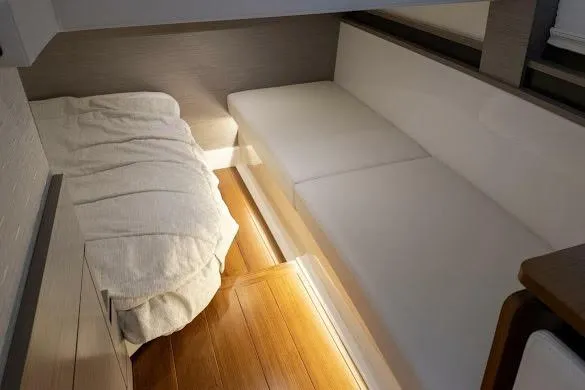 Slide: The Image of 2022 Tiara Sport 43 LE interior cabin with cozy bedding and sleek seating. - 29