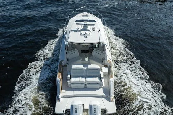 Slide: The Image of 2022 Tiara Sport 43 LE luxury boat cruising on open water. - 3