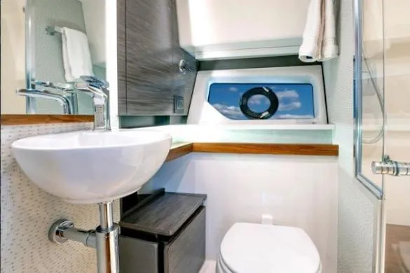 Slide: The Image of 2022 Tiara Sport 43 LE yacht bathroom with modern sink, toilet, and window view. - 35