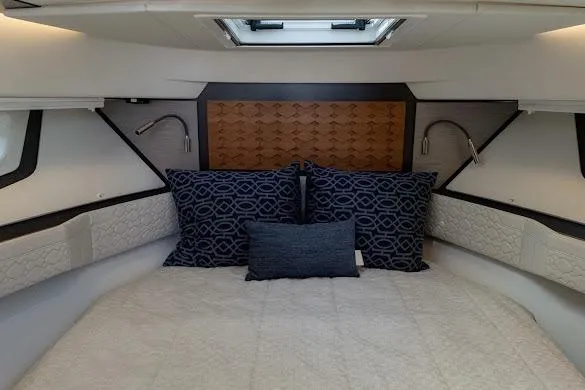 Slide: The Image of Luxurious cabin interior of 2022 Tiara Sport 43 LE with elegant bedding and modern lighting. - 36