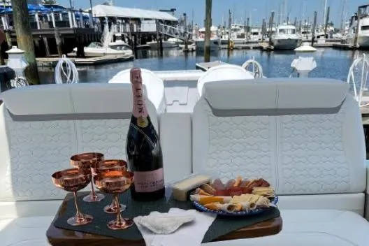 Slide: The Image of Luxury yacht Tiara Sport 43 LE 2022 with champagne and charcuterie at marina. - 8