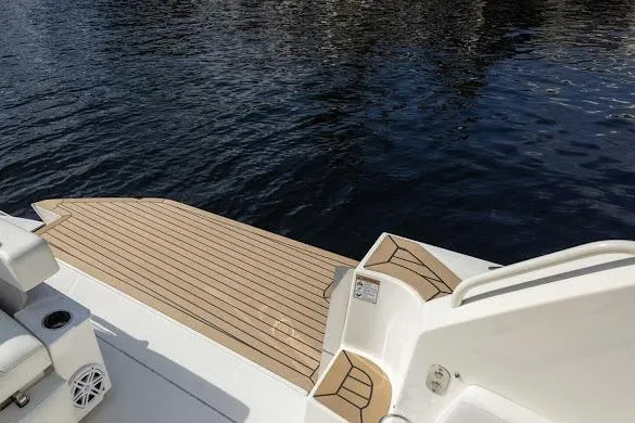 Slide: The Image of 2022 Tiara Sport 43 LE boat with teak deck by the water. - 9