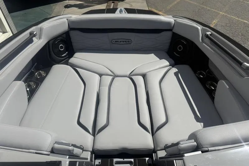 Slide: The Image of 2025 Supra SA 575 boat interior with luxurious gray seating and cup holders. - 10
