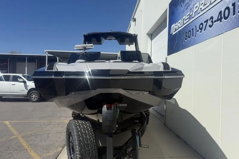Slide: The Image of 2025 Supra SA 575 boat on trailer outside Marine Products store. - 3