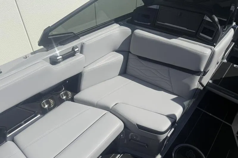 Slide: The Image of 2025 Supra SA 575 boat interior with luxurious gray seating and cup holders. - 7