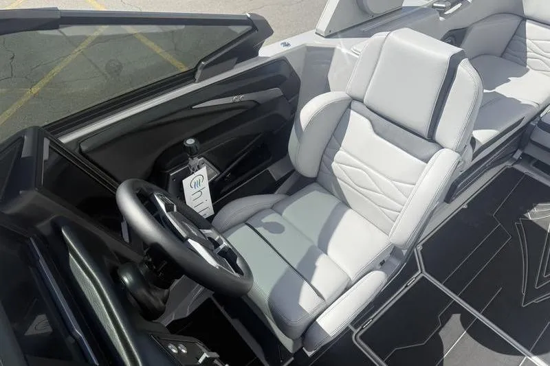 Slide: The Image of 2025 Supra SA 575 boat interior with sleek gray seating and modern steering wheel. - 9