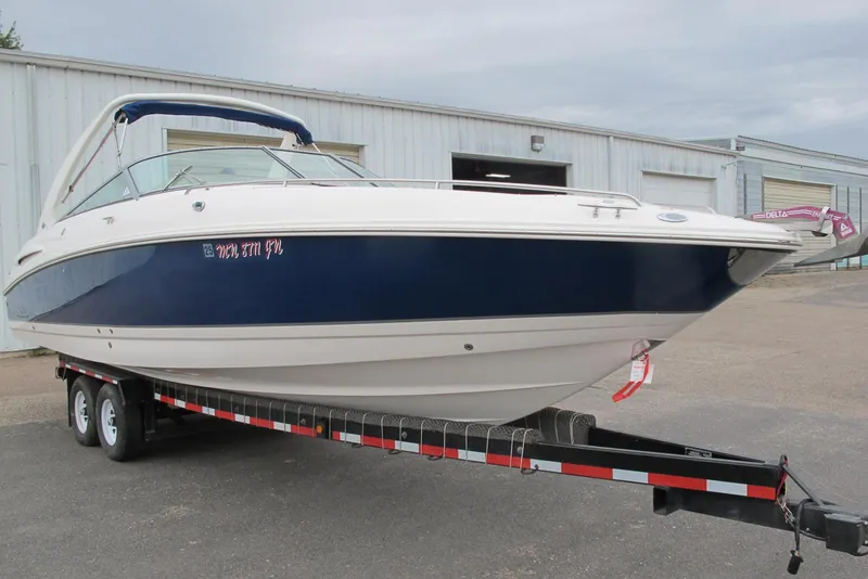 Slide: The Image of 2003 Chaparral 280 SSi boat on trailer, parked outside a warehouse. - 1