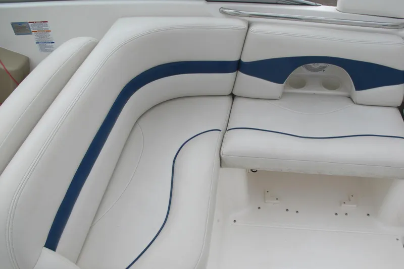 Slide: The Image of 2003 Chaparral 280 SSi boat interior with white and blue cushioned seating. - 10