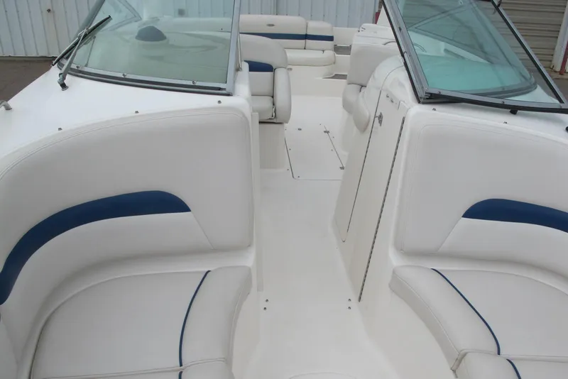 Slide: The Image of 2003 Chaparral 280 SSi boat interior with white and blue seating, windshield view. - 5