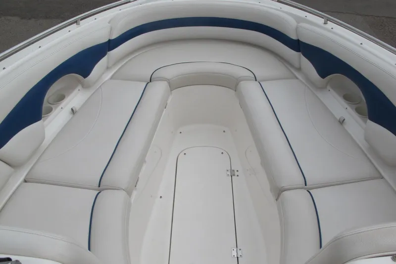 Slide: The Image of 2003 Chaparral 280 SSi boat interior with white and blue cushioned seating. - 6