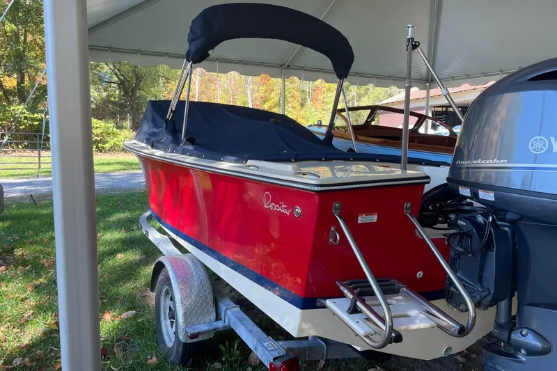 Slide: The Image of 2020 Rossiter 20 Coastal Cruiser boat with red hull and Yamaha outboard motor. - 1