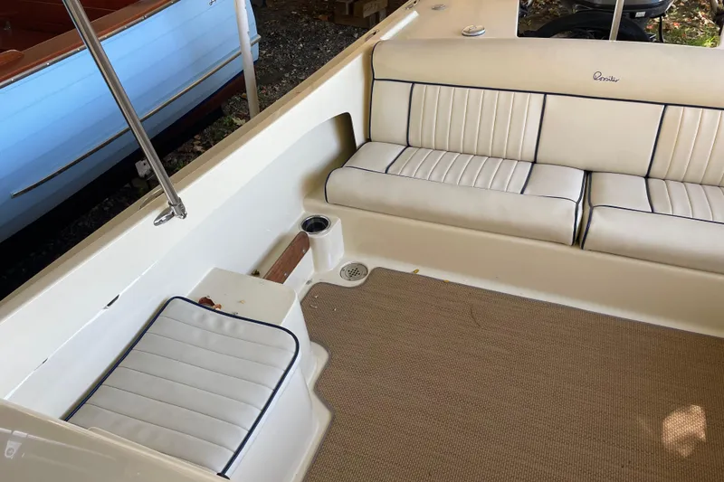 Slide: The Image of 2020 Rossiter 20 Coastal Cruiser interior with beige seating and carpeted floor. - 17