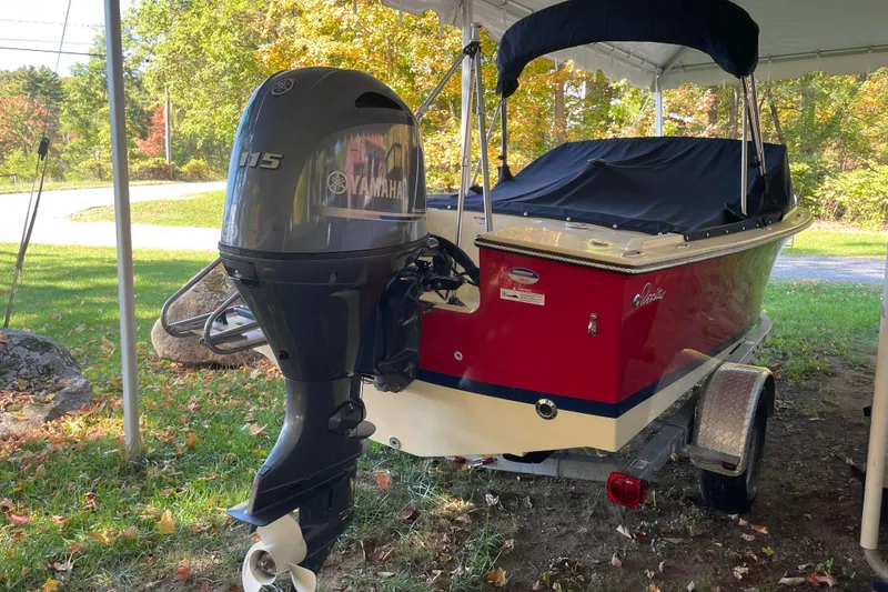 Slide: The Image of 2020 Rossiter 20 Coastal Cruiser with Yamaha 115 outboard motor, parked on a trailer. - 2