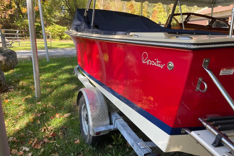 Slide: The Image of Red 2020 Rossiter 20 Coastal Cruiser boat on trailer, parked outdoors. - 4