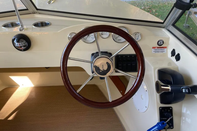 Slide: The Image of 2020 Rossiter 20 Coastal Cruiser dashboard with wooden steering wheel and control panel. - 7