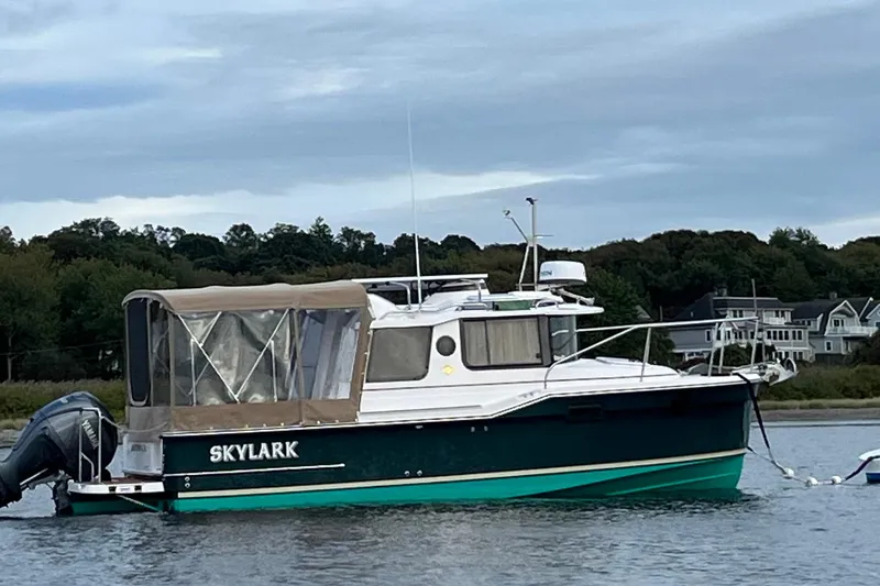 The Image of 2025 Ranger Tugs R23 boat named Skylark anchored on calm water. - 0