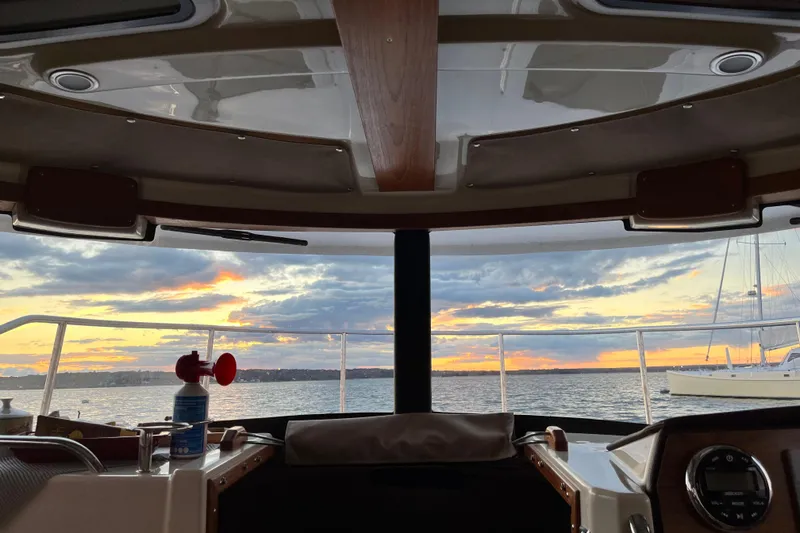 Slide: The Image of Interior view from 2025 Ranger Tugs R23 boat, overlooking sunset on the water. - 13