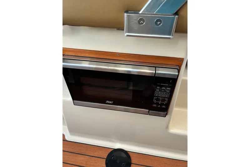 Slide: The Image of Microwave in 2025 Ranger Tugs R23 boat interior, featuring wood accents and modern design. - 29