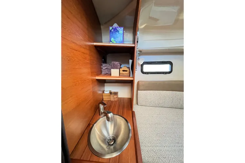 Slide: The Image of Interior of 2025 Ranger Tugs R23 with sink, shelves, and window. - 33