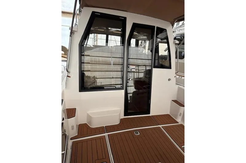 Slide: The Image of 2025 Ranger Tugs R23 boat interior with sleek design and wooden flooring. - 6