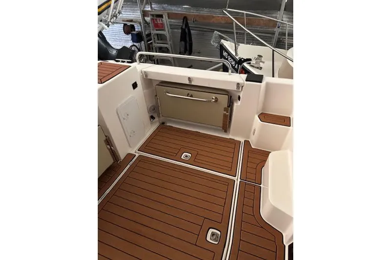 Slide: The Image of 2025 Ranger Tugs R23 boat deck with teak flooring and storage compartments. - 7