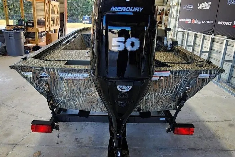 Slide: The Image of 2026 Tracker Grizzly 1648 SC boat with Mercury 50 engine in a garage setting. - 10