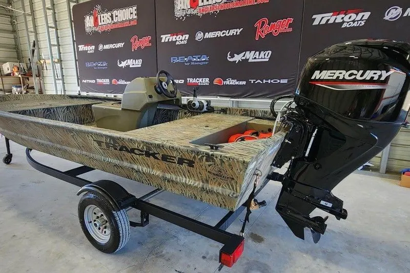 Slide: The Image of 2026 Tracker Grizzly 1648 SC boat with Mercury engine in showroom. - 7