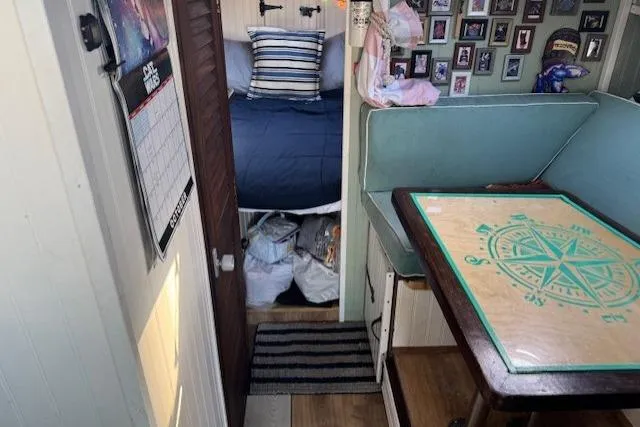 Slide: The Image of Interior of a 1981 Silverton Convertible boat with cozy cabin and nautical decor. - 10