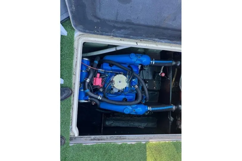 Slide: The Image of Engine compartment of a 1981 Silverton Convertible boat, featuring blue components. - 3