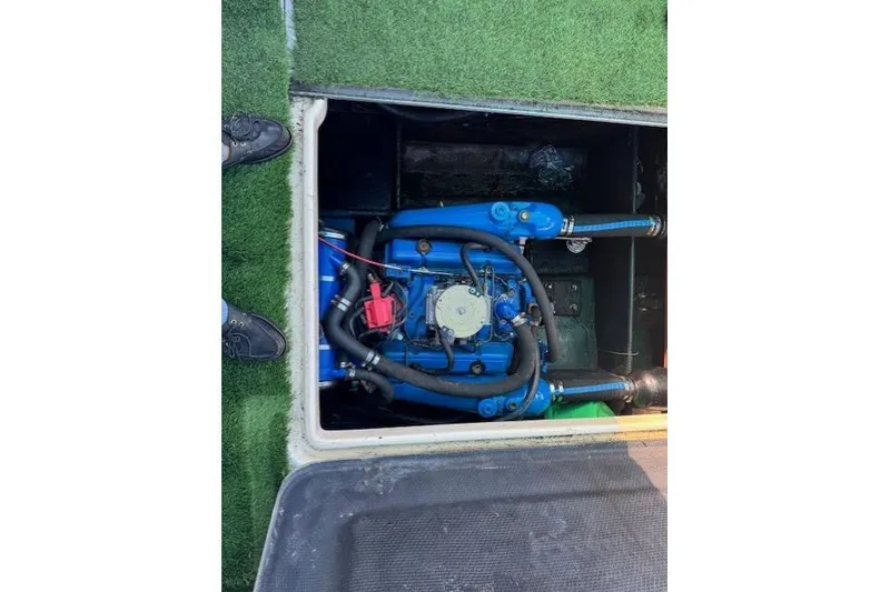 Slide: The Image of 1981 Silverton Convertible engine compartment with visible blue engine and hoses. - 4