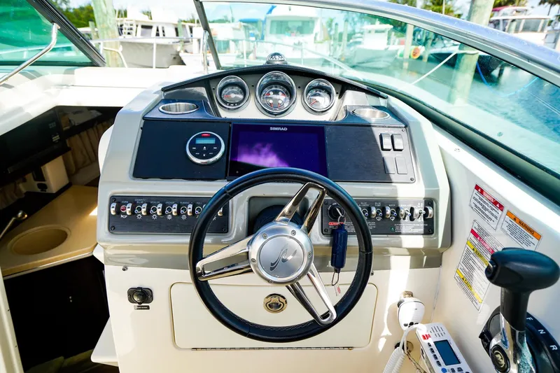 Slide: The Image of Steering console of a 2015 Sea Ray 260 Sundancer boat with modern controls and gauges. - 14