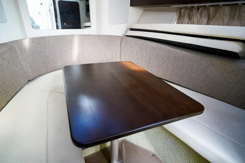 Slide: The Image of Interior of 2015 Sea Ray 260 Sundancer with cozy seating and wooden table. - 18