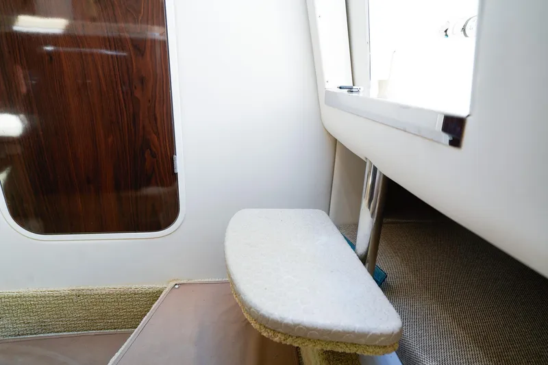 Slide: The Image of Interior of 2015 Sea Ray 260 Sundancer boat, featuring a wooden door and carpeted step. - 25