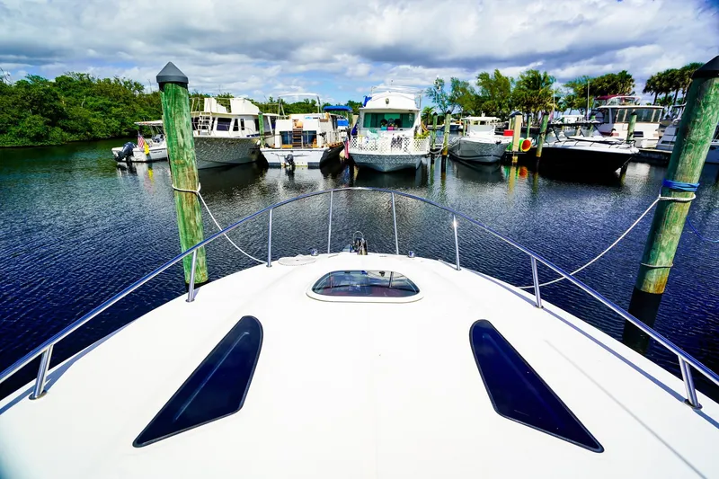 Slide: The Image of Bow view of 2015 Sea Ray 260 Sundancer docked in a marina. - 26