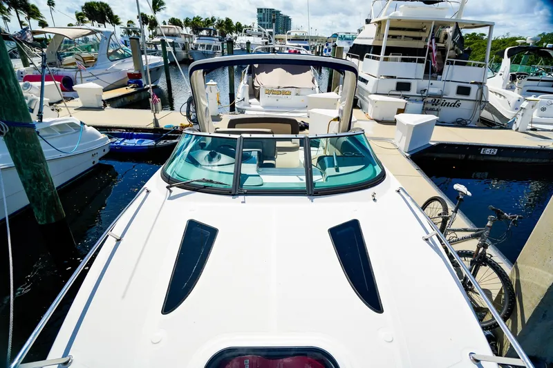 Slide: The Image of 2015 Sea Ray 260 Sundancer docked at marina, surrounded by other boats. - 28