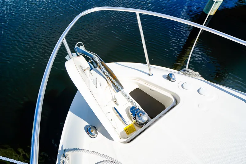 Slide: The Image of Bow of 2015 Sea Ray 260 Sundancer with anchor and railing, docked on calm water. - 30
