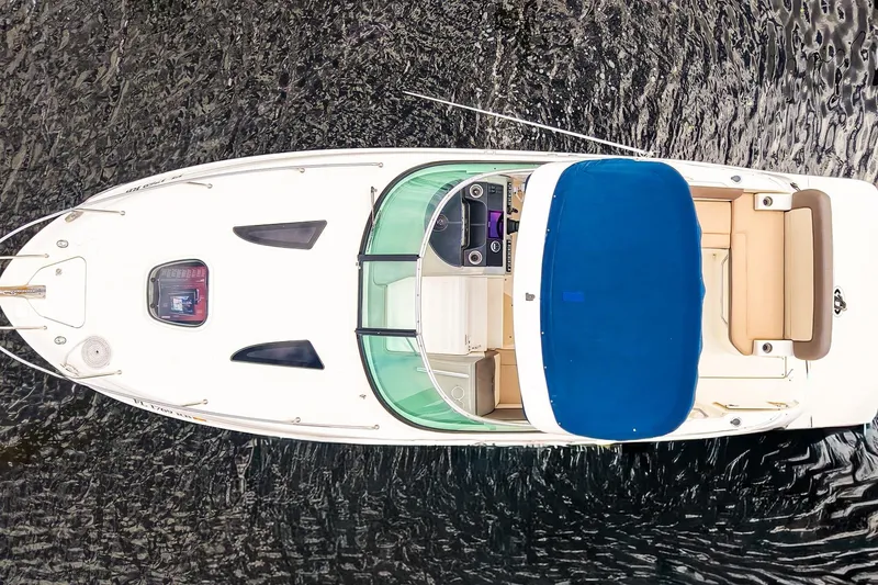 Slide: The Image of Overhead view of 2015 Sea Ray 260 Sundancer boat with blue canopy on water. - 4