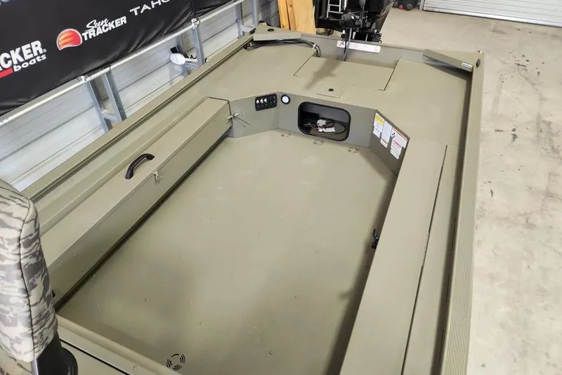 Slide: The Image of 2026 Tracker Grizzly 1654 T Sportsman boat interior with storage compartments and seating. - 7