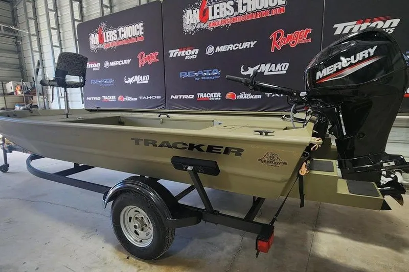 Slide: The Image of 2026 Tracker Grizzly 1654 T Sportsman boat with Mercury outboard motor on display. - 8