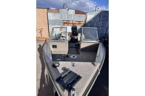 Slide: The Image of 2001 Lund 1700 Fisherman boat with open deck, parked outdoors. - 2
